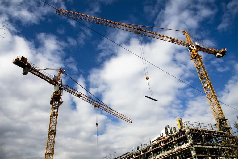 cranes working on a building