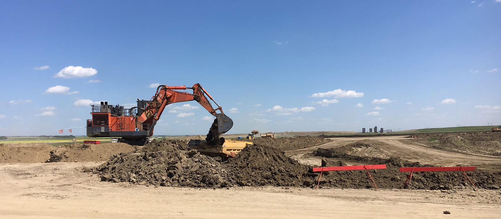 loader digging up dirt on construction site